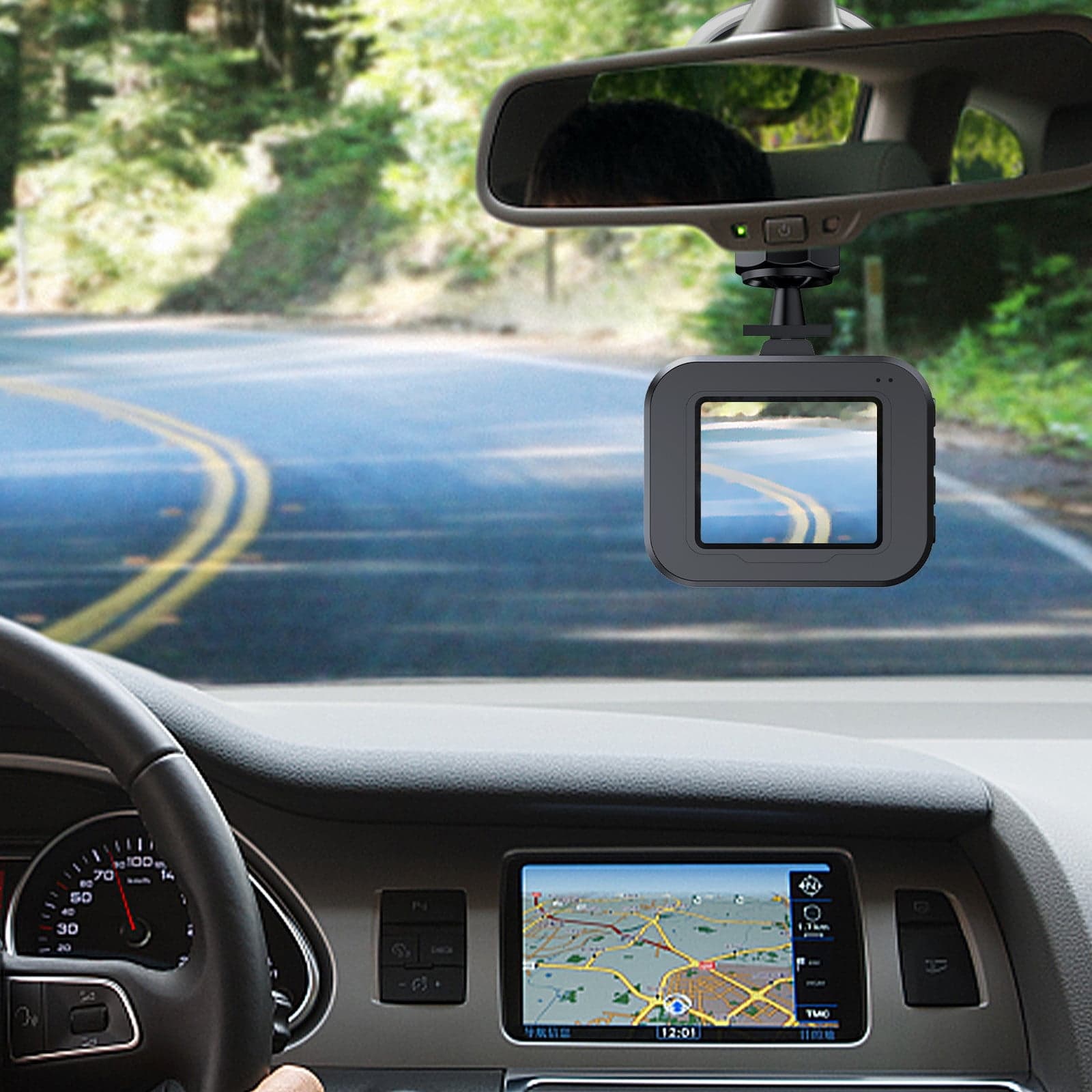 Dashcam mounted below a rearview mirror captures a winding road through a car's front windshield.