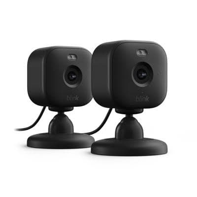 Two black Blink indoor security cameras with rounded square bodies mounted on small circular stands.